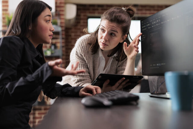 Experts in cloud migration discussing code.